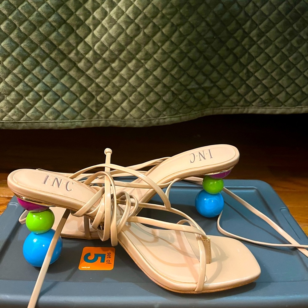 Beige strapped sandals with beautiful detailing on heel. Brand new